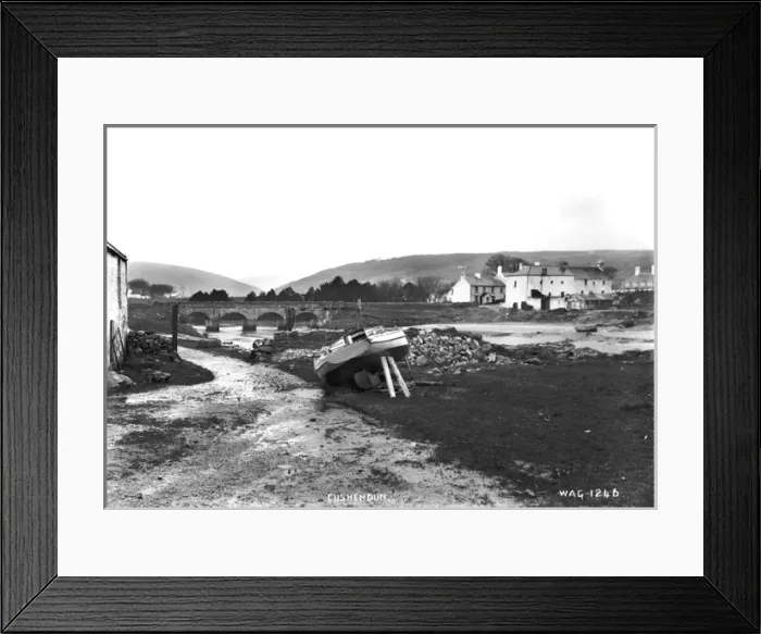 Framed Print : Cushendun - a view from the shore looking up to the bridge with a boat in the foreground Framed Print : Cushendun - a view from the shore looking up to the bridge with a boat in the foreground