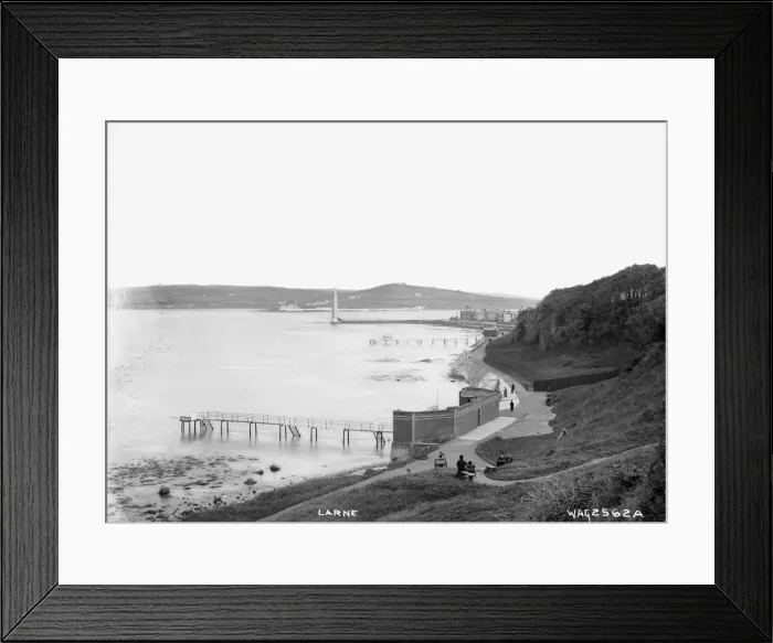 Framed Print : Larne - an elevated view looking down on the coastal walk with the bathing piers Framed Print : Larne - an elevated view looking down on the coastal walk with the bathing piers