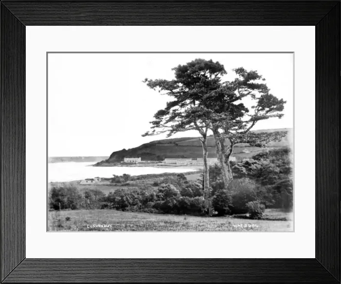Framed Print : Cushendun - a view of the town, taken from a distance, with a tree in the foreground Framed Print : Cushendun - a view of the town, taken from a distance, with a tree in the foreground