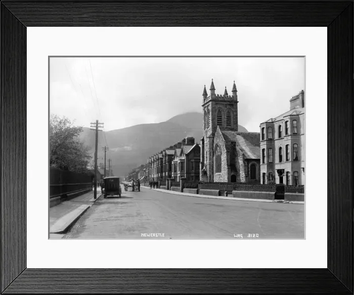 Framed Print : Newcastle - a low level view of the Main street with a Church to the right Framed Print : Newcastle - a low level view of the Main street with a Church to the right