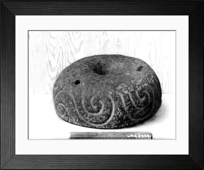 Framed Print : A inscribed round stone with a ruler beside for scale Framed Print : A inscribed round stone with a ruler beside for scale