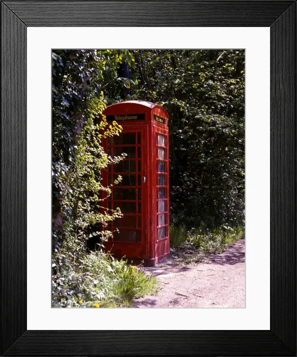 Framed Print : Old style telephone box in a quiet country village road Framed Print : Old style telephone box in a quiet country village road