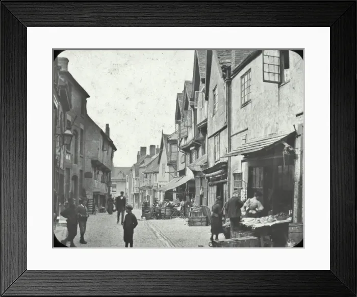 Framed Print : Coventry - view along Street, shops, goods? on pavement, people Framed Print : Coventry - view along Street, shops, goods? on pavement, people