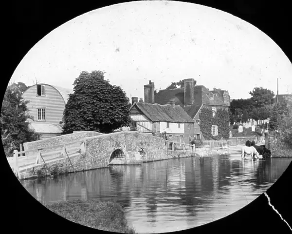 Eynsford. Small bridge over river, houses in background