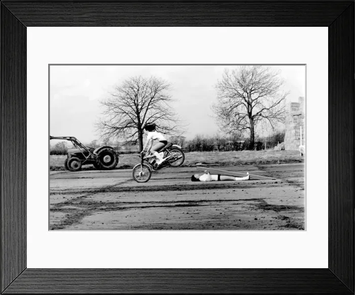 Framed Print : Stunt woman rides over wooden plank Framed Print : Stunt woman rides over wooden plank