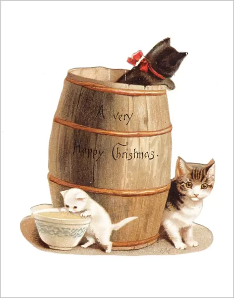 Three kittens with barrel on a cutout Christmas card