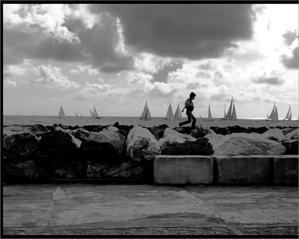 Small boy on seawall Marina di Pisa Italy