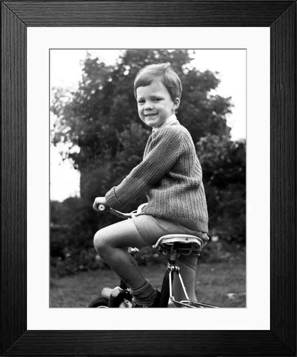 Framed Print : Young Boy on his bicycle, smiling Framed Print : Young Boy on his bicycle, smiling