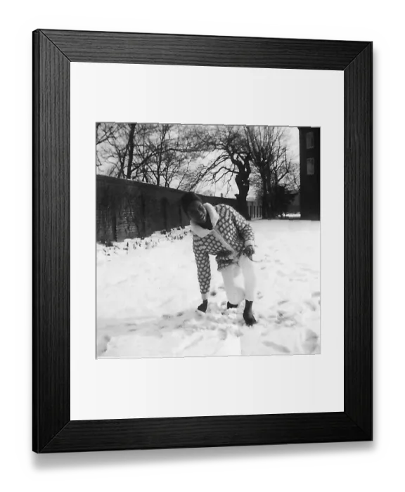 Framed Print : Black teenage girl touching and kneeling in the snow in Nott Framed Print : Black teenage girl touching and kneeling in the snow in Nott
