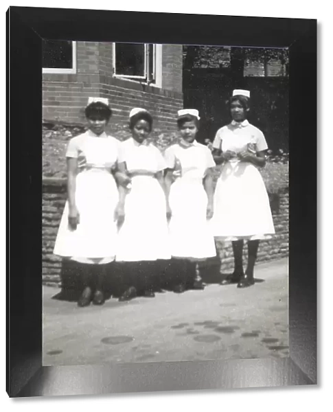 Four black nurses stand by the hospital wall in Nottingham