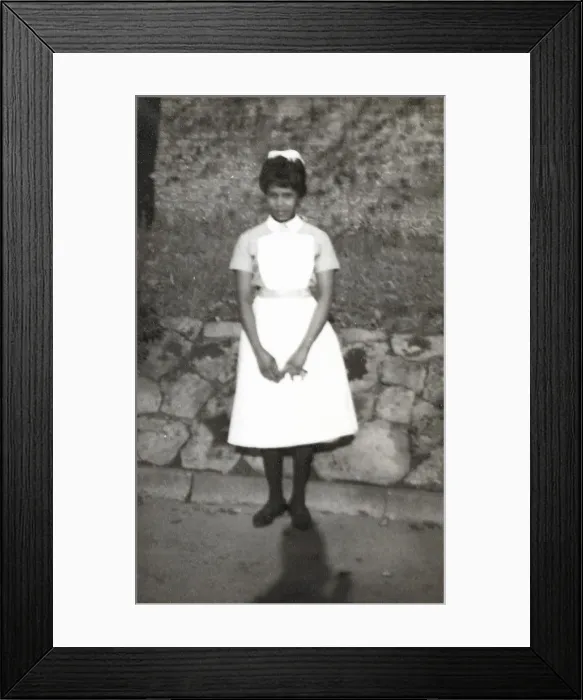 Framed Print : Black nurse standing by a wall in the grounds of Womans Hos Framed Print : Black nurse standing by a wall in the grounds of Womans Hos