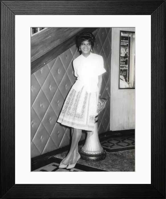 Framed Print : British Caribbean lady leaning against a stand - Sherwood Ro Framed Print : British Caribbean lady leaning against a stand - Sherwood Ro