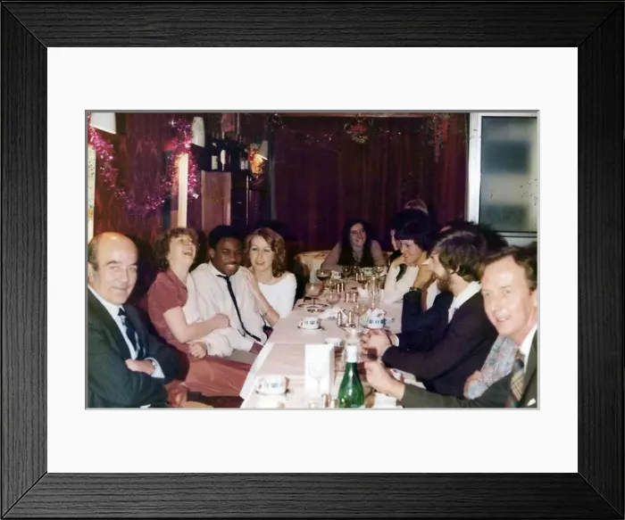 Framed Print : British Caribbean man at a Christmas office dinner party