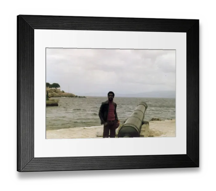 Framed Print : Errol Holder standing beside the cannon on a Greek Island Framed Print : Errol Holder standing beside the cannon on a Greek Island