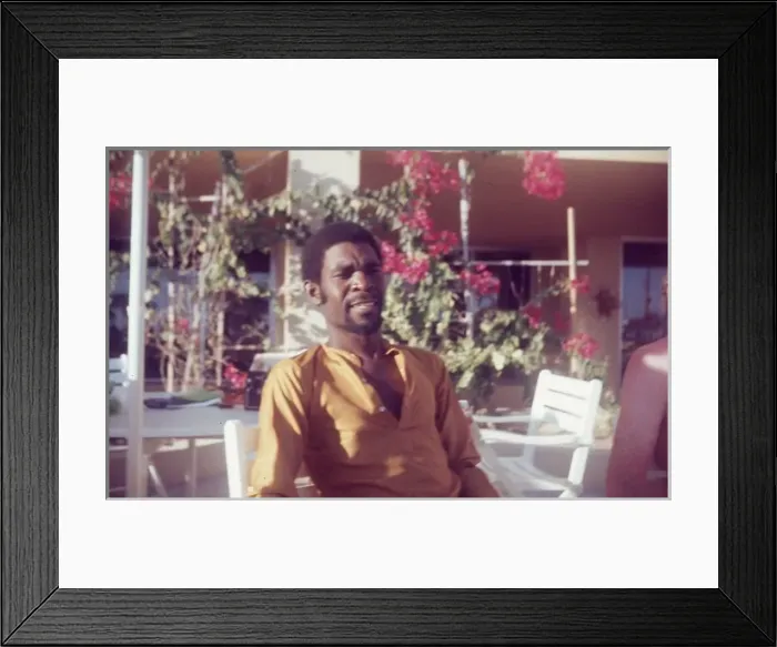 Framed Print : British Caribbean man sitting by pool at Holiday Inn Salalah Framed Print : British Caribbean man sitting by pool at Holiday Inn Salalah