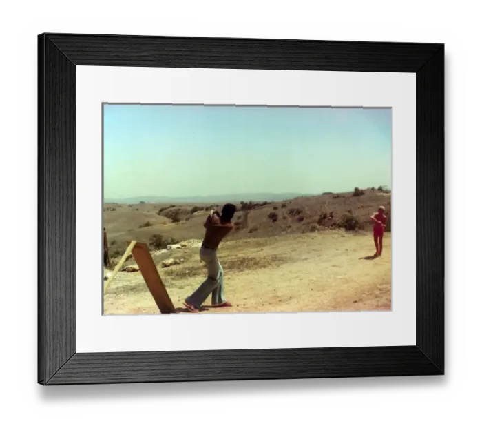 Framed Print : British Caribbean man playing cricket in Oman Framed Print : British Caribbean man playing cricket in Oman