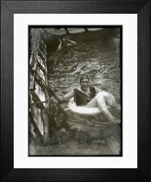 Framed Print : Woman swimming with a lifebelt in a pool Framed Print : Woman swimming with a lifebelt in a pool