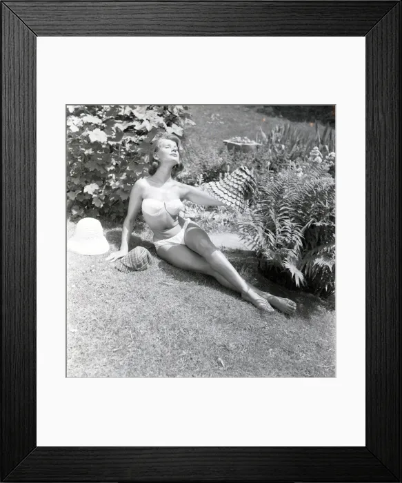 Framed Print : Model sunbathing in a white bikini Framed Print : Model sunbathing in a white bikini