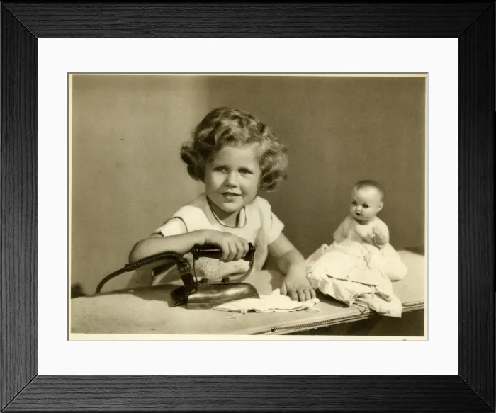 Framed Print : Little girl ironing her dolls clothes Framed Print : Little girl ironing her dolls clothes