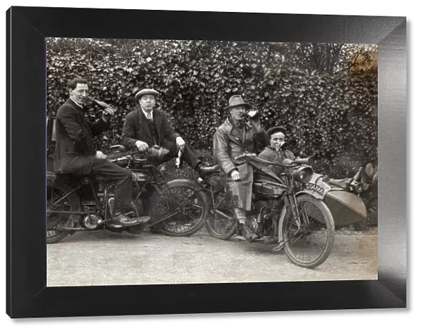 Men sitting on their veteran motorcycles drinking beer