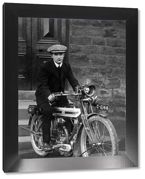 Young man on a 1910  /  14 Triumph motorcycle