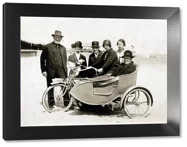 Group of people with vintage motorcycle combination on beach