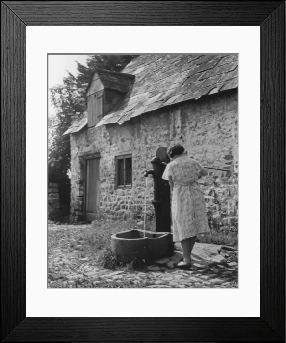 Framed Print : Woman using water pump Framed Print : Woman using water pump