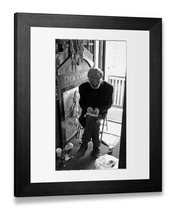 Framed Print : Seated artisan working on an object, England Framed Print : Seated artisan working on an object, England