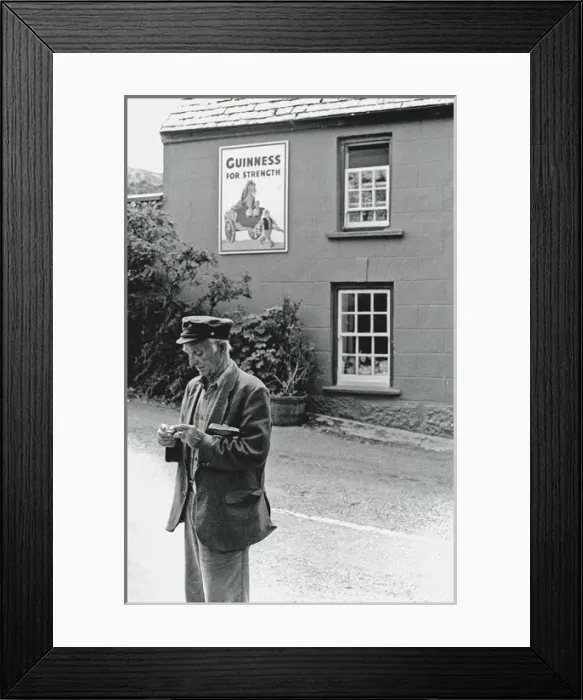 Framed Print : Man rolling cigarette in the street, Ireland Framed Print : Man rolling cigarette in the street, Ireland