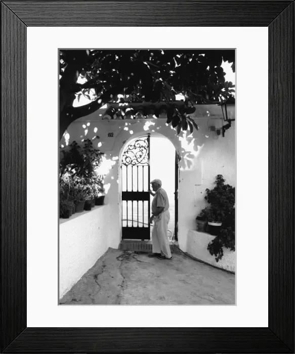 Framed Print : Man at a wrought iron gate, Spain Framed Print : Man at a wrought iron gate, Spain