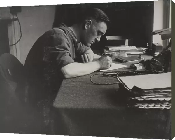 Bob West. Photograph: Bob West.Shows a man seated at a desk writing.From