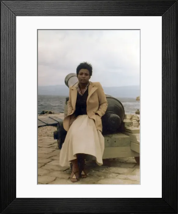Framed Print : Lorna Holder, sits by a cannon on a Greek Island Framed Print : Lorna Holder, sits by a cannon on a Greek Island