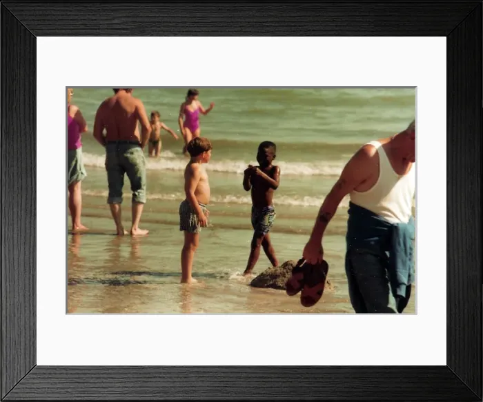 Framed Print : British Caribbean boy and English boy on the beach in Bright Framed Print : British Caribbean boy and English boy on the beach in Bright