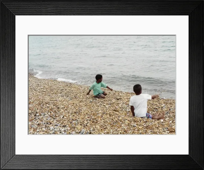 Framed Print : Two British Caribbean boys playing with stones on Brighton Framed Print : Two British Caribbean boys playing with stones on Brighton