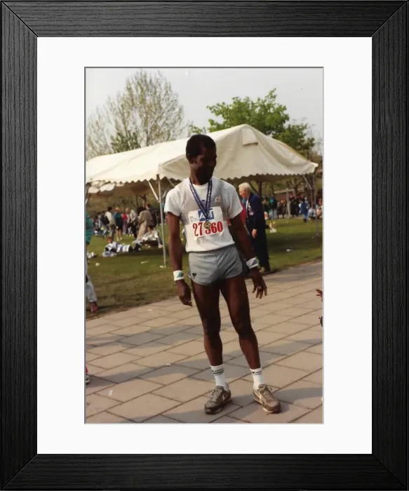 Framed Print : British Caribbean marathon runner standing with medal Framed Print : British Caribbean marathon runner standing with medal