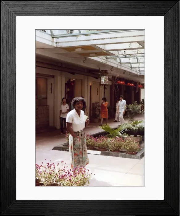 Framed Print : British Caribbean woman by a floral arrangement, Hong Kong Framed Print : British Caribbean woman by a floral arrangement, Hong Kong