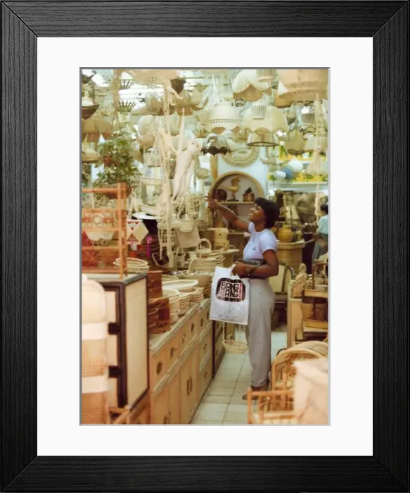 Framed Print : British Caribbean woman points to an item, novelty shop, Hon Framed Print : British Caribbean woman points to an item, novelty shop, Hon
