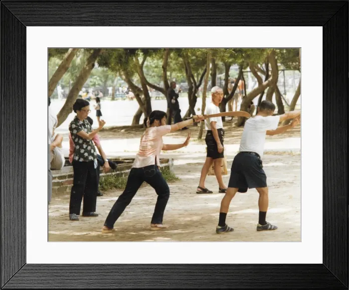 Framed Print : Man and woman shadow boxing in the park in Hong Kong Framed Print : Man and woman shadow boxing in the park in Hong Kong