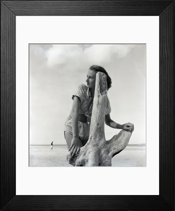 Framed Print : Woman on beach with driftwood Framed Print : Woman on beach with driftwood