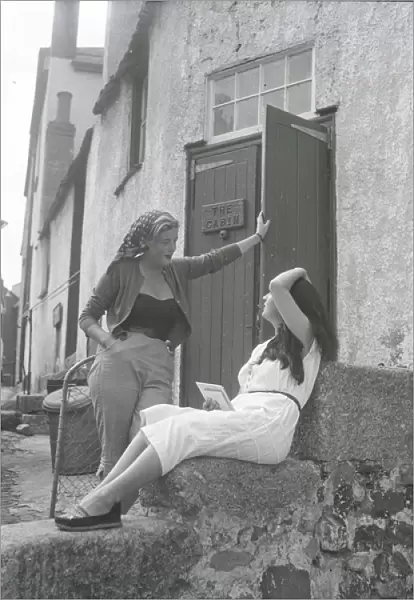 Girls chatting on the steps of The Cabin, St Ives, Cornwall