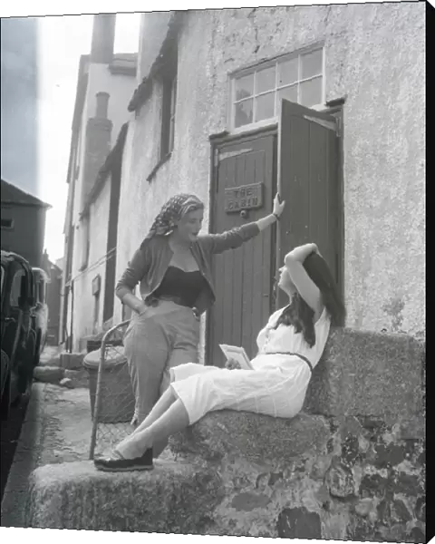 Girls chatting on the steps of The Cabin, St Ives, Cornwall