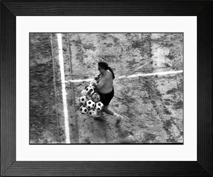 Framed Print : Man with footballs on training pitch, Spain Framed Print : Man with footballs on training pitch, Spain