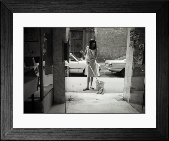 Framed Print : Young woman cleaning in doorway, Valencia, Spain Framed Print : Young woman cleaning in doorway, Valencia, Spain
