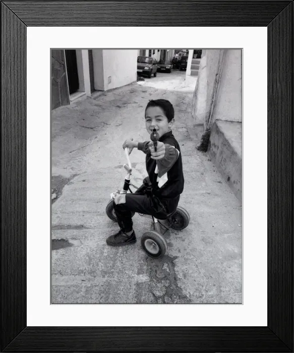 Framed Print : Small boy pointing a toy gun, Malaga, Spain Framed Print : Small boy pointing a toy gun, Malaga, Spain