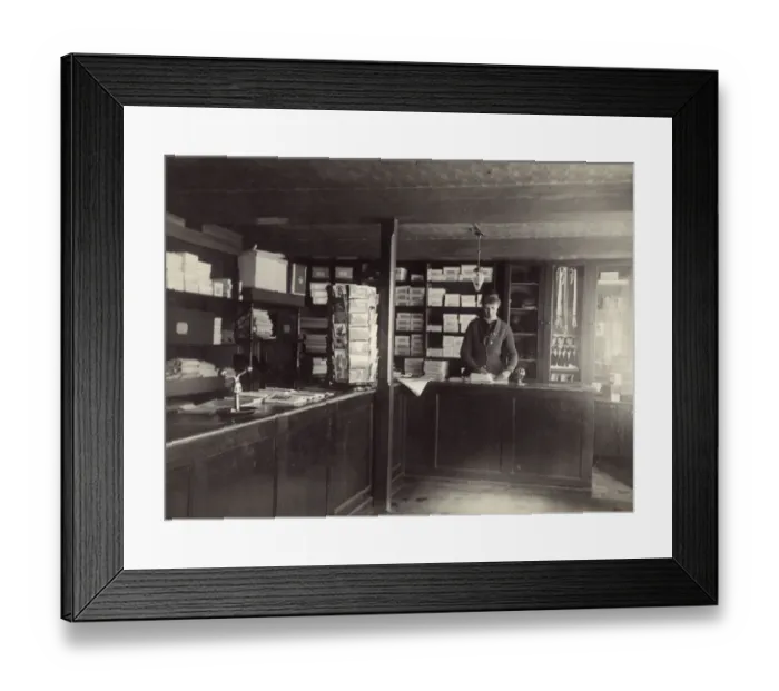 Framed Print : Shop interior with female assistant, USA Framed Print : Shop interior with female assistant, USA