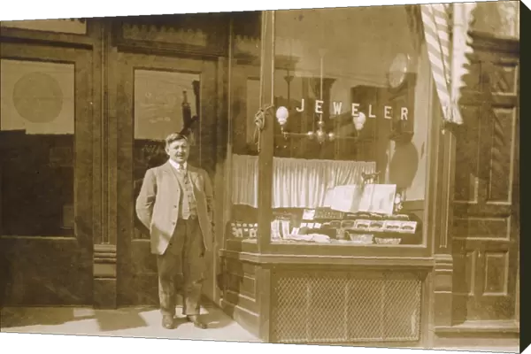 Owner standing outside jewellers shop, USA