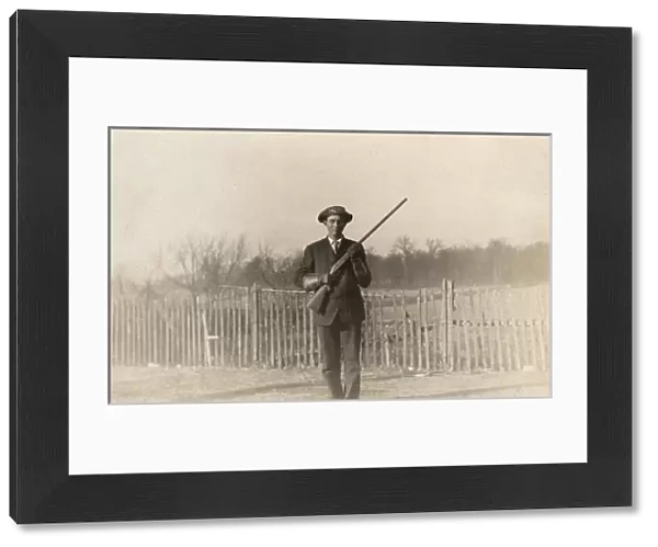 Man posing with rifle