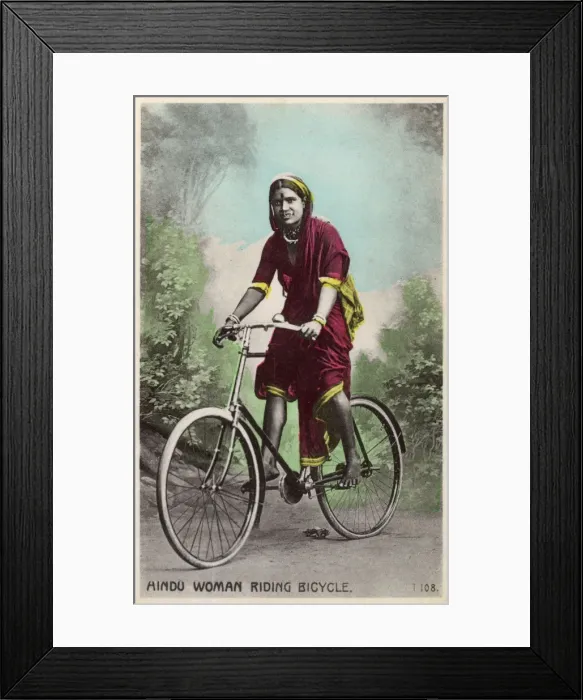 Framed Print : Studio portrait, Hindu woman riding a bicycle, India Framed Print : Studio portrait, Hindu woman riding a bicycle, India