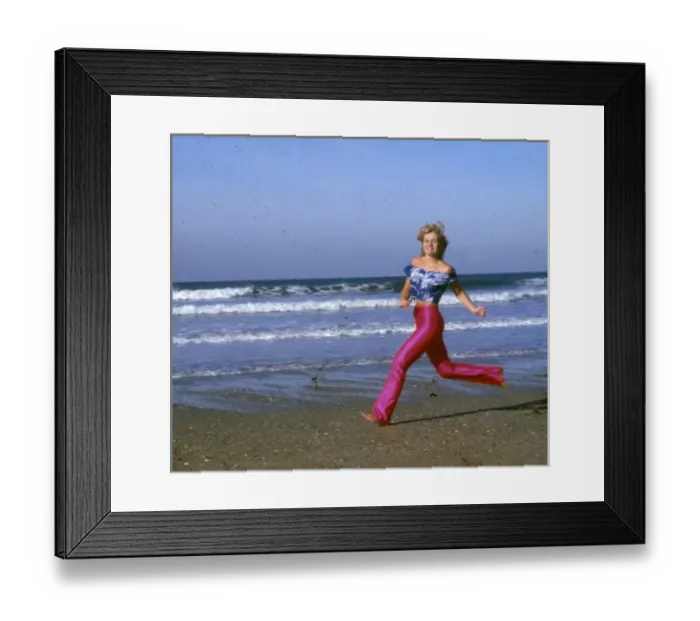 Framed Print : Woman running on a beach, Cornwall Framed Print : Woman running on a beach, Cornwall