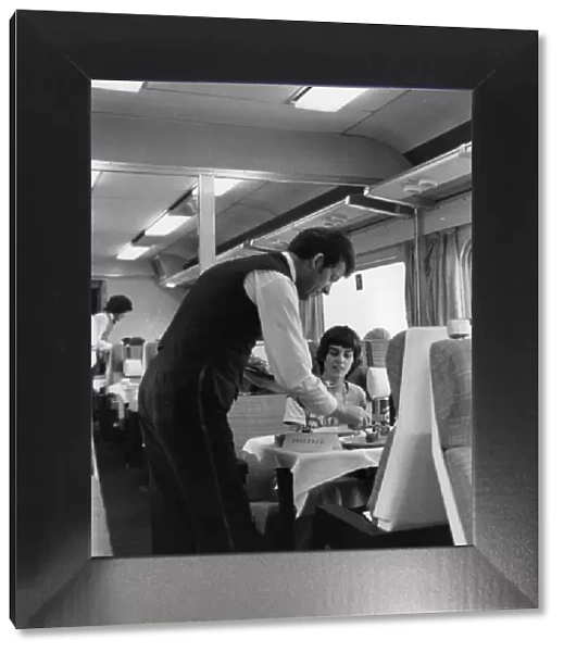 British Rail dining car, with waiter serving a passenger